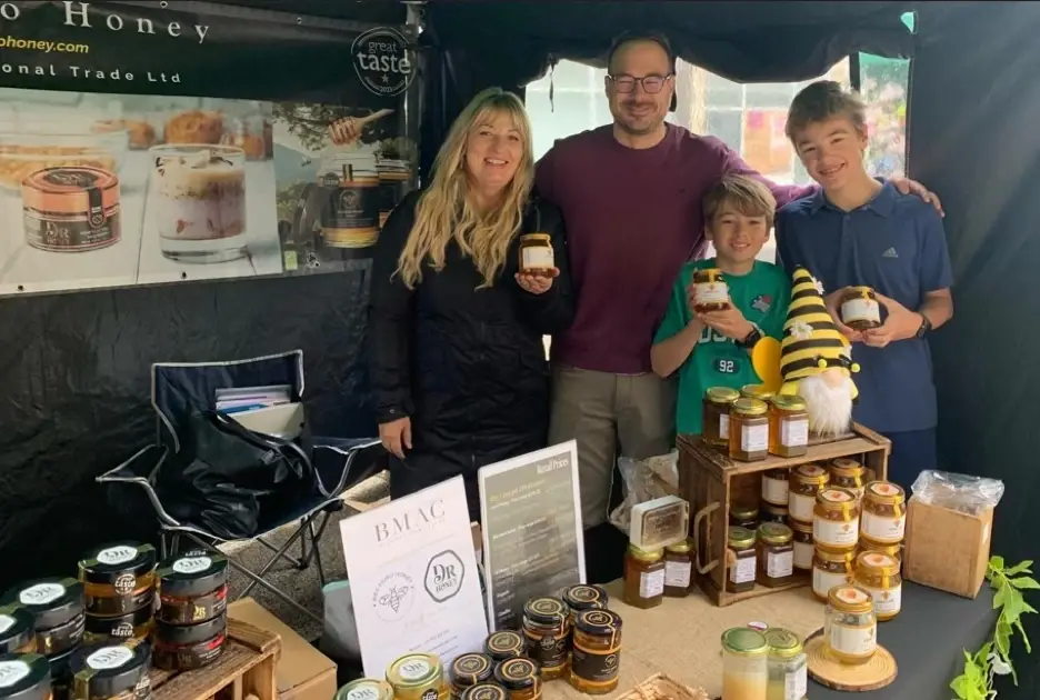 The Honey Collab family at a market stall